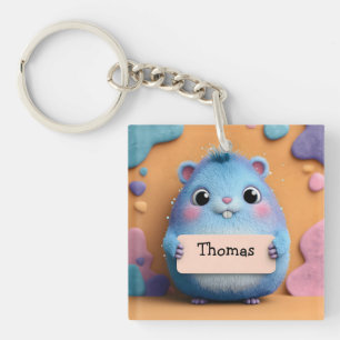Porte-clefs Hamster bleu bouffant tenant un signe avec nom