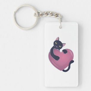 Porte-clefs Joli chat noir s'accrochant à un gros cœur