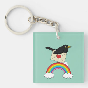 Porte-clefs Merle volant au-dessus de l'arc-en-ciel avec une l