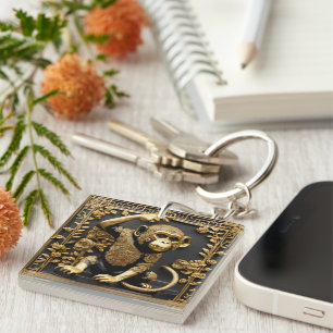 Porte-clefs Monkey or et cadre ornemental noir