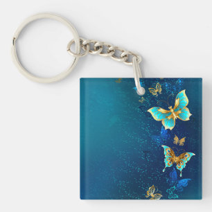 Porte-clefs Papillons d'or sur un Arrière - plan bleu