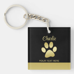 Porte-clefs Paw chien brillant or sur arrière - plan noir
