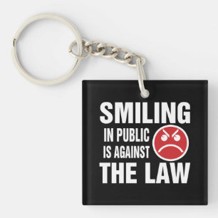 Porte-clefs Sourire en public est contre la loi
