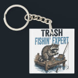 Porte-clefs Trash Fishin' Expert Raccoon<br><div class="desc">Are you a fan of raccoons and fishing? This funny 'Trash Fishin' Expert' design features a master raccoon angler on a wooden dock with his gear. Perfect for anyone who loves trash panda memes, outdoor fishing trips, and a good laugh. This vintage-style illustration is a great gift for fishers, outdoorsmen,...</div>