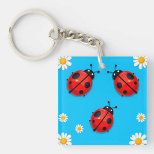 Porte-clefs Trois coccinelles colorées sur fond bleu