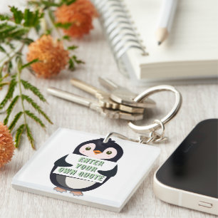 Porte-clefs Un pingouin tenant un panneau avec un texte person