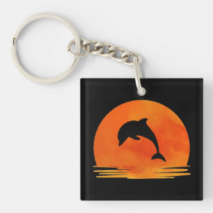Porte-clefs Une silhouette de dauphin sautant au coucher du so