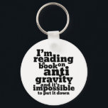 Porte-clés Book on Anti Gravity Funny Science Geek Puns<br><div class="desc">I'm reading a book on anti gravity and it's impossible to put it down. Funny science pun design for those who love to study science. Cool and humorous quote merchandise for college students majoring in Physics. Perfect for scientist and physicist. Great Christmas gift and birthday present for family and friends....</div>