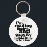 Porte-clés Book on Anti Gravity Funny Science Geek Puns<br><div class="desc">I'm reading a book on anti gravity and it's impossible to put it down. Funny science pun design for those who love to study science. Cool and humorous quote merchandise for college students majoring in Physics. Perfect for scientist and physicist. Great Christmas gift and birthday present for family and friends....</div>