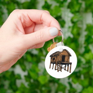 Porte-clés Cabane en bois rustique traditionnelle sur pilotis