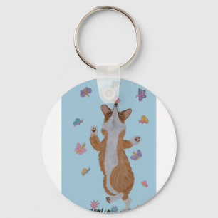 Porte-clés Corgi gallois dansant avec des papillons