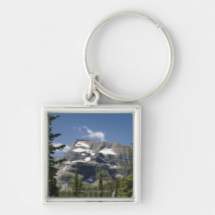 Porte-clés Crête de montagne entre les arbres sous un ciel