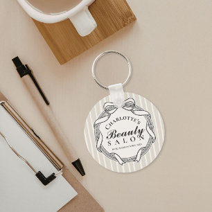 Porte-clés de salon de beauté à cadre orné de crèm