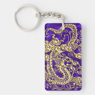 Porte-clés Dragon d'or embouti sur papier satin violet