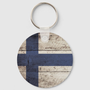 Porte-clés Drapeau de la Finlande sur un vieux grain de bois