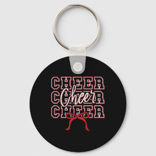 Porte-clés Fille de cheerleading sportive avec un nœud rouge
