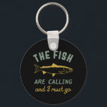 Porte-clés Funny Fishing Quote The Fish Are Calling I Must Go<br><div class="desc">Funny and humorous design for fisherman, angler, those who love river and lake fishing. This vintage, retro and distressed merchandise is great to wear on your fishing trip to the cabin by the wood. Bring your gears, fishing rod, fishing reel and let's catch some fish. Great Christmas gift and birthday...</div>