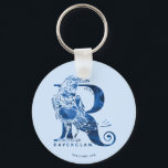 Porte-clés Harry Potter | Aguamenti RAVENCLAW™ Graphique<br><div class="desc">Découvrez ce graphique de Ravenclaw basé sur le sort d'eau Aguamenti. Il y a un corbeau bleu devant une lettre géante "R" avec le nom "Ravenclaw" écrit ci-dessous.</div>