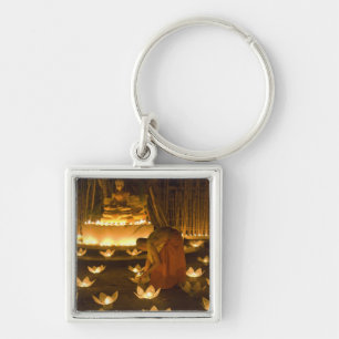 Porte-clés Moines allumant des bougies khom loy et des lanter