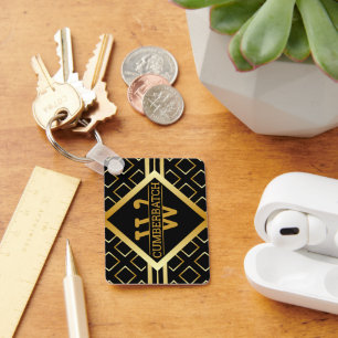 Porte-clés Motif de monogramme géométrique en noir et or FAUX
