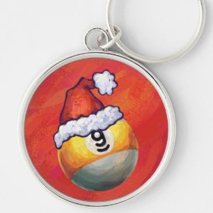 Porte-clés Nine Ball dans le chapeau de Santa sur fond rouge