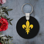 Porte-clés Noir avec Fleur de Lys Or<br><div class="desc">La Fleur de Lys est considérée comme un porte-bonheur : ce porte-clés noir avec Fleur de Lys couleur or pourrait faire un joli cadeau !</div>