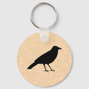 Porte-clés Oiseau noir de corneille sur un modèle de