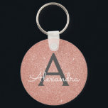 Porte-clés Pailleté et scintillant monogramme or rose<br><div class="desc">Pailleté et scintillant élégant porte-clés or rose. Ces porte-clés peuvent être personnalisés avec votre initiale et votre prénom et sont un cadeau idéal pour un enterrement de vie de jeune fille,  une fête de mariage ou un anniversaire.</div>