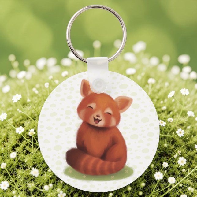 Porte-clés Panda roux (A keychain with a hand-painted red panda, cute and smiling, laid on sunlit moss.)