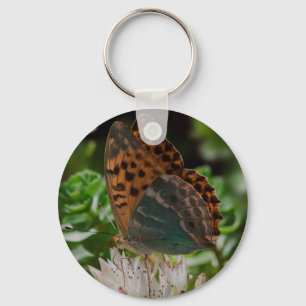 Porte-clés Papillon noir et orange avec des taches.