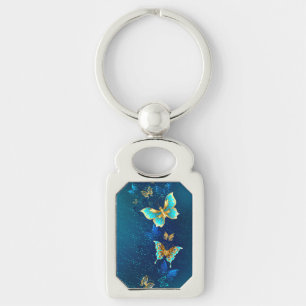 Porte-clés Papillons dorés sur fond bleu