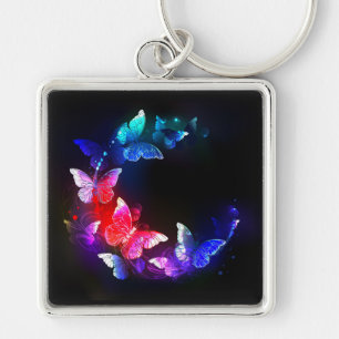 Porte-clés Papillons néon lumineux de nuit sur fond noir