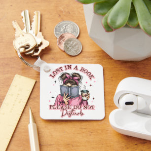 Porte-clés Perdu dans un livre...