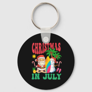 Porte-clés Père Noël surfant sur la plage hawaïenne de Noël e