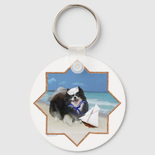 Porte-clés Pomeranian noir à la plage