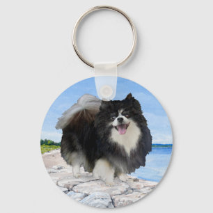 Porte-clés Pomeranian noir au bord de la mer