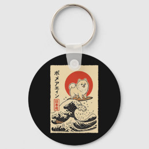 Porte-clés Poméranien surfant sur une vague japonaise