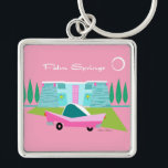 Porte-clés Porte - clé du bouton Retro Pink Palm Springs<br><div class="desc">Entre l’arrière - plan rose, la maison moderne turquoise du milieu du siècle et la voiture classique des années 1950, ce design ne pouvait pas être plus Palm Springs s’il le disait dans les nuages. Oh, attendez, il le dit dans les nuages ! La pierre bleue et turquoise de la...</div>
