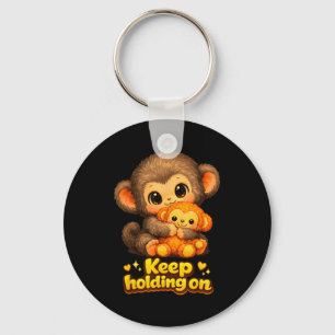 Porte-clés Singe qui frappe avec un ours en peluche câlinant 