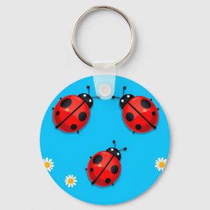 Porte-clés Trois coccinelles colorées sur fond bleu
