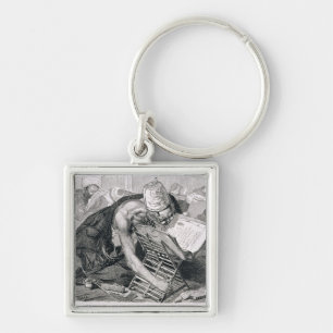 Porte-clés Un homme instruit absorbé dans Coran