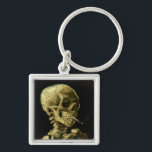Porte-clés Van Gogh Fumer du squelette<br><div class="desc">Porte - clé représentant la peinture à l’huile de Vincent van Gogh,  Skull of a Skeleton with Burning Cigarette (1885-86). Un grand cadeau pour les amateurs de post-impressionnisme et d'art hollandais !</div>