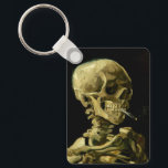 Porte-clés Van Gogh Fumer du squelette<br><div class="desc">Porte - clé représentant la peinture à l’huile de Vincent van Gogh,  Skull of a Skeleton with Burning Cigarette (1885-86). Un grand cadeau pour les amateurs de post-impressionnisme et d'art hollandais !</div>
