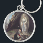 Porte-clés Vierge Marie de Lourdes<br><div class="desc">Elle est vénérée sous ce titre par l'église catholique romaine en raison de ses apparitions qui se sont produites à Lourdes,  en France. Première apparition du 11 février 1858,  dont Bernadette Soubirous.</div>