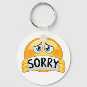 Porte-clés Visage d'émoji triste et désolé tenant un panneau