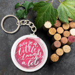 Porte-clés Wine a Little Laugh A Lot<br><div class="desc">Round button keychain features fun text "Wine a Little Laugh A Lot" on a red wine stain. Keychains make memorable gifts for family and friends or create for yourself.</div>