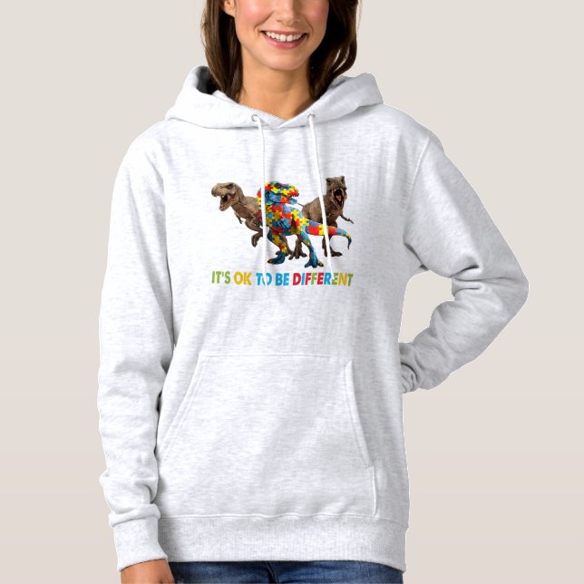 Pull À Capuche Dinosaur Autism Awareness design features a dinosa (Devant)