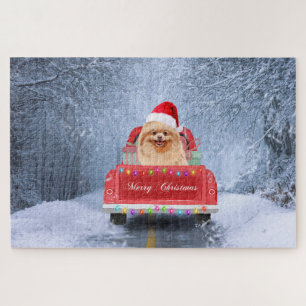 Puzzle Chien Pomeranian dans la neige assis dans un camio