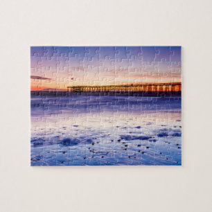 Puzzle Coucher de soleil sur la jetée et la plage de Vent