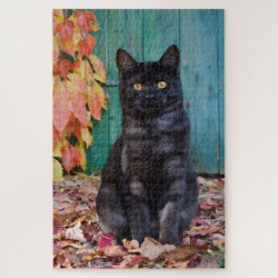 Puzzle Cute chaton noir avec porte bleue Feuille rouge -